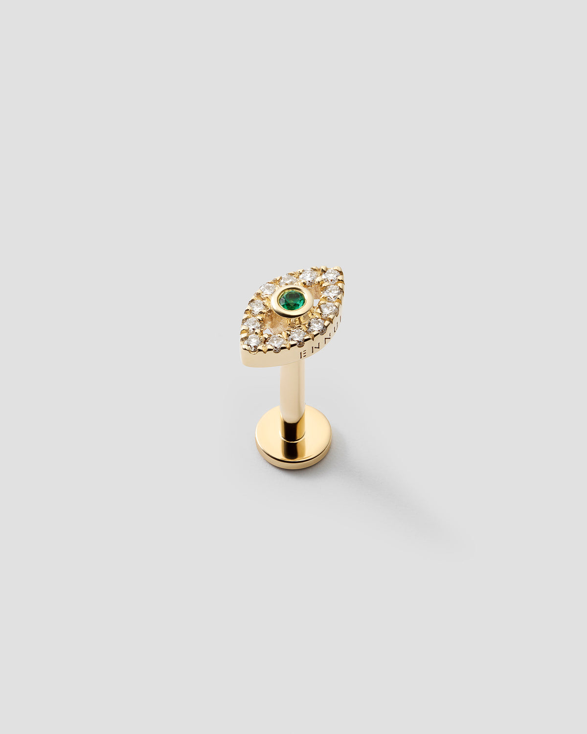 Eirene eye labret in 14k yellow gold, set with an emerald and natural diamonds, detail view.