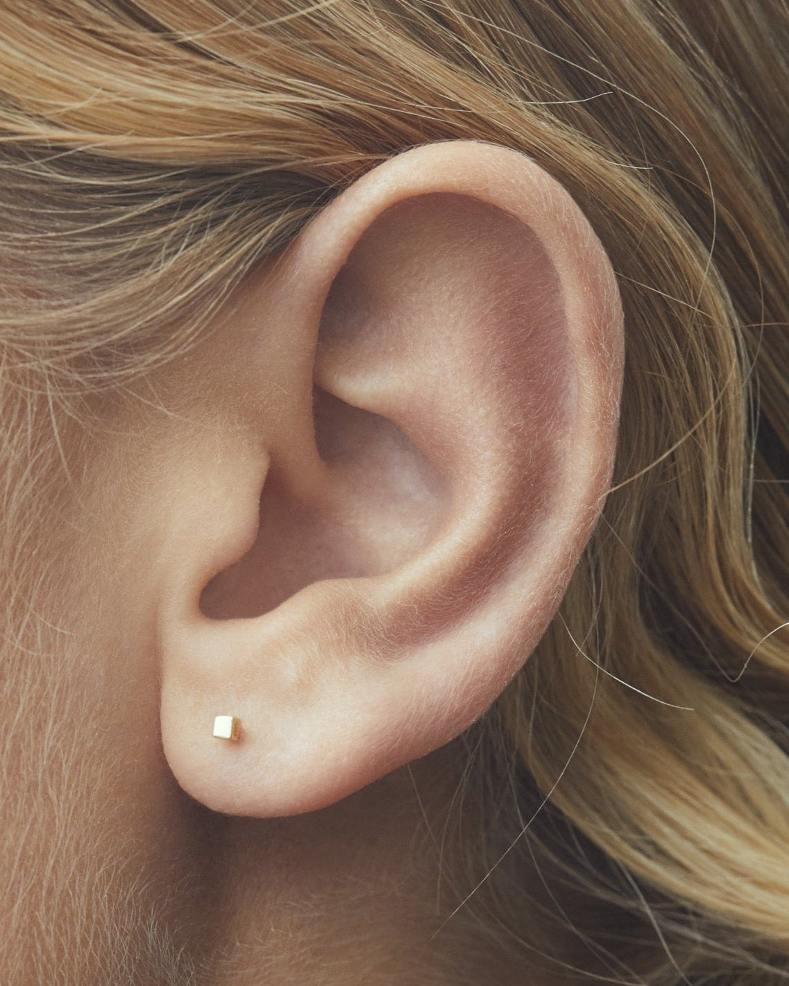 hip to be square labret yellow gold on ear