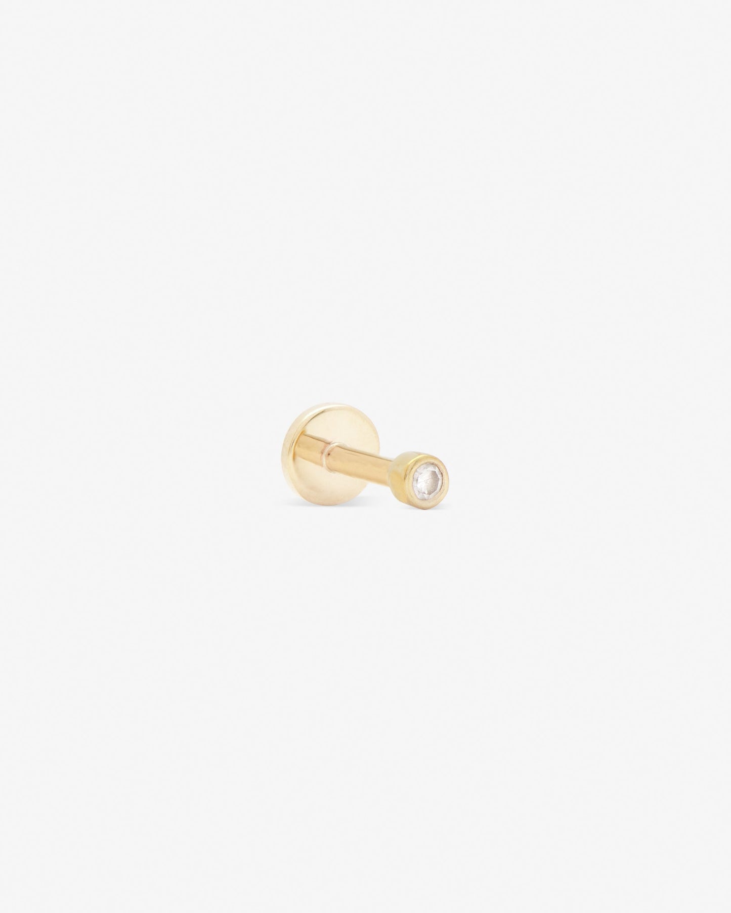single stone labret with white diamond set in yellow gold from side