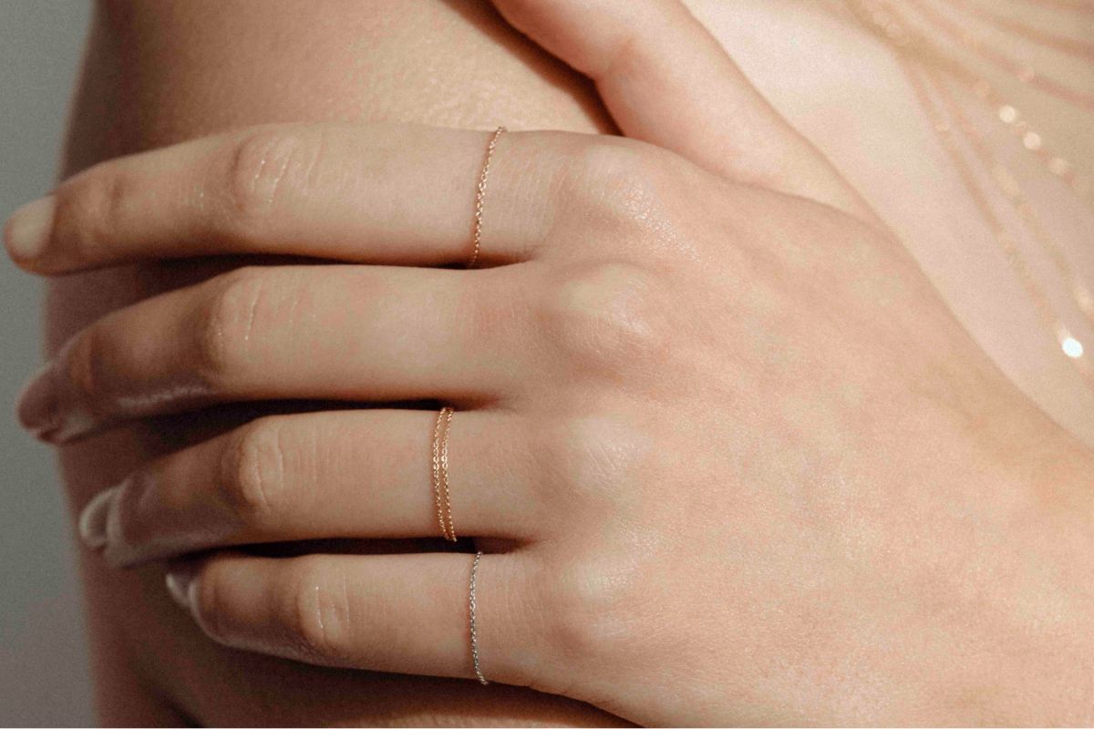 Layered chain necklaces in recycled gold, photographed close up.