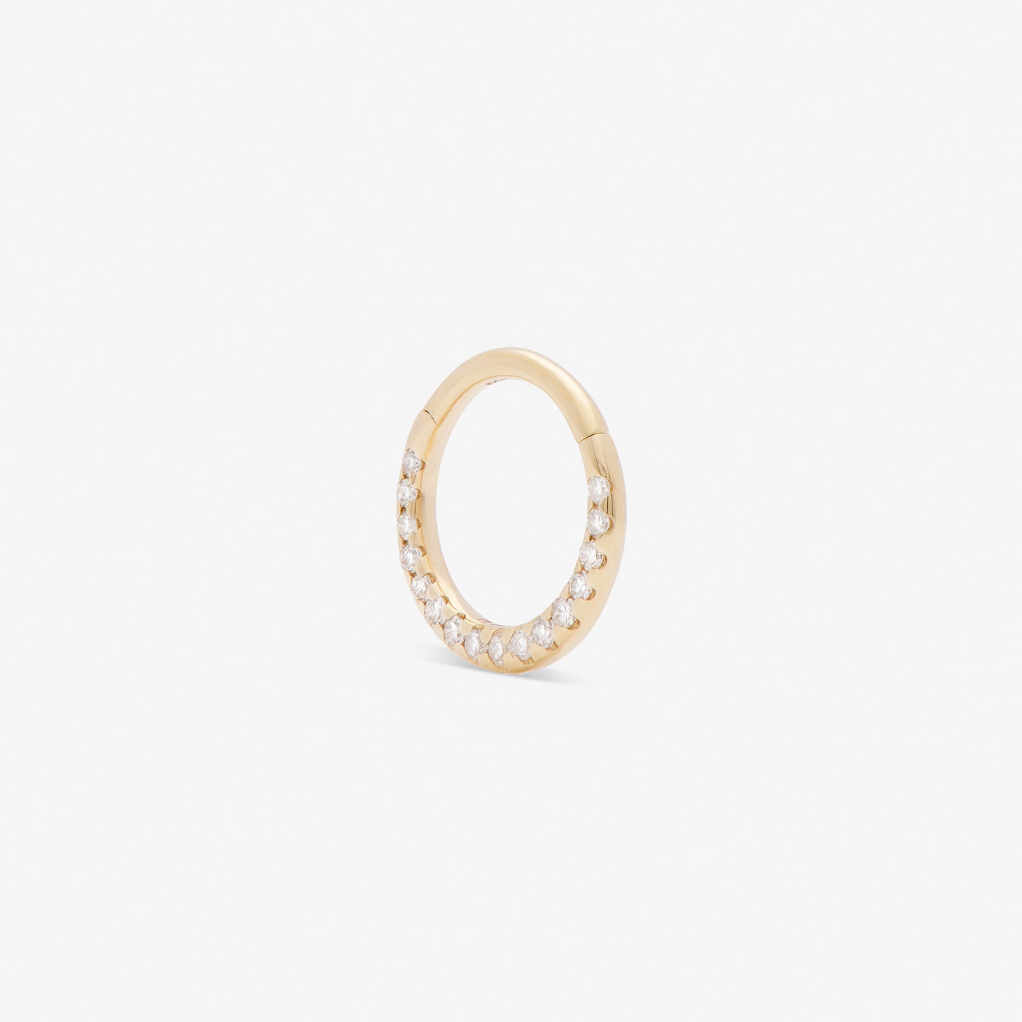 septum huggie with white diamonds set in yellow gold from side